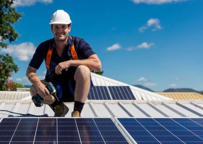 Solar-Panel-Installer-Smiling-with-Drill